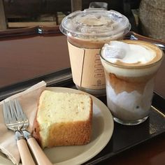 there is a piece of cake next to a cup of coffee