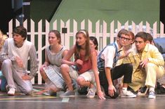 a group of young people sitting on the ground