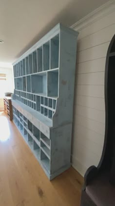 an empty room with a large book shelf