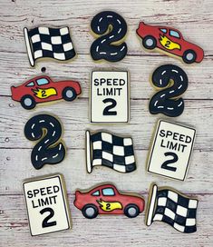 cookies decorated to look like race cars with numbers on them and the words speed limit