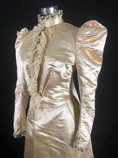 "Museum Deaccession: Beautiful and rare ladies Historical Wedding Ensemble dated to the early 1890s in great condition. As you can see from the photos, it presents quite well. Hand made in New York by A F Jammes with fine couture detailing for a Miss EB Jennings. (hand written on a sewn in piece of silk) Both pieces are 100% Silk Duchess Satin in a Golden Champagne color Fitted Bodice: Falls to natural waist at sides but dips down in the front and back High neck bodice trimmed down the front wit Historical Wedding, Gown With Jacket, High Neck Lace Dress, Silk Evening Gown, Vintage Wedding Photos, Duchess Satin, Lace Veils, Victorian Clothing, Couture Details