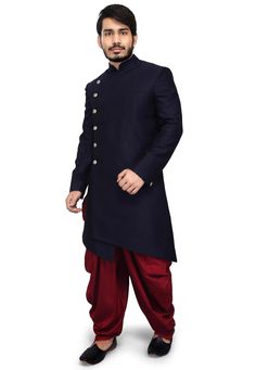 A Long and royal indian ethnic indian wear sherwani especially designed for men in order to make an occasion very especial. It is elegantly made with hands to bring about a feel about India. Look your best on your special day while you carry your sharp attitude with this indowestern sherwani paired with a churidar. Colored in oxford blue color and black embellished with woven work. Available with gold color cotton silk churidar. Slip on to some matching mojari and a matching safa to complete the Traditional Bandhgala For Winter Groom, Traditional Winter Bandhgala For Groom, Long Sherwani With Resham Embroidery, Traditional Drape Nehru Jacket For Winter, Bollywood Style Long Sleeve Bandhgala For Winter, Bollywood Style Bandhgala For Winter Designer Wear, Bollywood Bandhgala For Winter Designer Wear, Winter Bollywood Style Long Sleeve Bandhgala, Long Sleeve Sherwani With Dabka Work For Groom