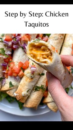 a hand holding a burrito filled with chicken and veggies on top of a white plate