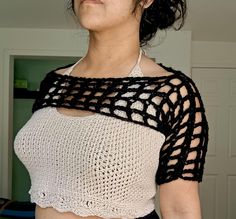 a woman wearing a black and white crochet top