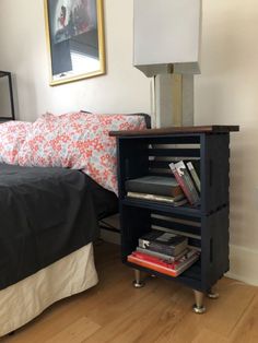 a bed room with a neatly made bed and a night stand next to the bed