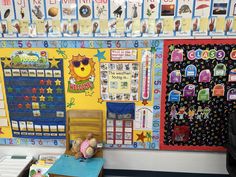 there is a desk and chair in the room with many bulletin boards on the wall