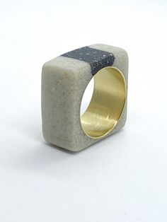 This listing is for a black and white cement and resin ring on brass. The ring consists of mostly white cement with an inlay of black cement and charcoal, mixed into resin over a brass ring. The ring is approximately a size 8, but can fit 7.5-8. All items are hand made and unique.  *PLEASE READ* After continuous wear, brass jewelry can develop a black residue (oxidation). This is very easily fixed by soaking your jewelry in lemon juice for no more than fifteen seconds, then rinsing it in water and polishing with a jewelry cloth (included) Store your jewelry in a dry location, preferably in a cloth bag or a jewelry box, as open air will accelerate the natural oxidation of the metal. Concrete Ring, Black Minimal, Concrete Jewelry, White Cement, Black Cement, Spiral Ring, Freshwater Pearl Ring, Lace Jewelry, Contemporary Ring