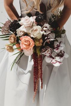 a woman holding a bouquet of flowers in her hands