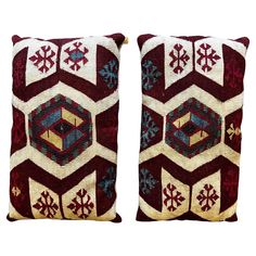 two red and white decorative pillows with snowflakes on the sides, one is made from wool