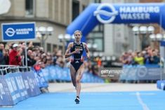 a woman running in a marathon with people watching