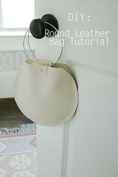 a round leather bag hanging on the wall