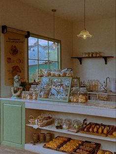 a bakery filled with lots of pastries and donuts on display next to a window