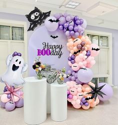 balloons and decorations are arranged in the shape of a happy birthday arch with bats, flowers, and ghostes