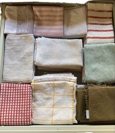 several folded towels are sitting in a drawer