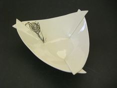 a white bowl with an intricate design on it