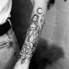 a woman's arm with a tattoo on it and a flower in the middle