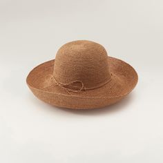 A hallmark Helen Kaminski silhouette, the Provence hat is handcrafted from over 14,000 stitches of sustainably harvested raffia. Paired with a classic rounded crown, the flexible brim can be rolled up or down for custom sun coverage. Hand-rolled raffia tie Turn-up brim Rounded crown Goldtone seed logo 100% Madagascan raffia Spot clean Made in Sri Lanka Measurements Brim: 4.72in Woven Toquilla Straw Bucket Hat With Curved Brim, Curved Brim Handwoven Toquilla Straw Bucket Hat, Handwoven Toquilla Straw Bucket Hat With Curved Brim, Woven Toquilla Straw Crochet Hat With Curved Brim, Elegant Hats With Curved Brim In Paper Straw, Brown Straw Hat With Curved Brim, Elegant Curved Brim Paper Straw Hat, Elegant Paper Straw Hat With Curved Brim, Handwoven Toquilla Straw Sun Hat With Curved Brim