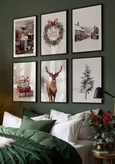 a bedroom decorated for christmas with green walls and pictures on the wall above the bed