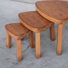 three wooden stools sitting next to each other