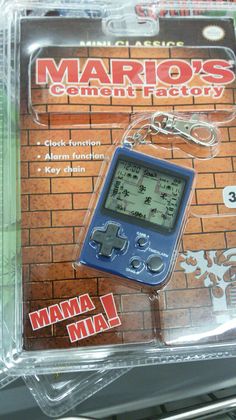 a gameboy keychain that is in the packaging for mario's cement factory