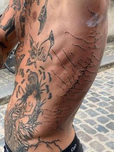 the back of a man with tattoos on his body