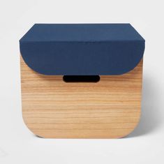 a wooden box with a blue cover on the top and bottom, sitting in front of a white background