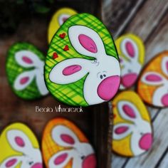 easter decorations with painted eggs in the shape of bunnies and bunny ears on wooden boards