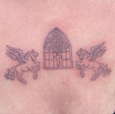 a woman's chest with an angel and a bird cage tattoo on the side