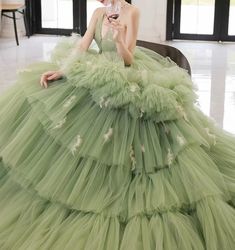 Step into a world of elegance and sophistication with our Sage Green Tiered Tulle Gown. This exquisite ball gown features a stunning tiered tulle skirt that creates a dramatic and voluminous silhouette, perfect for making a grand entrance. The corset back adds a touch of timeless charm while ensuring a perfect fit. The gown's sage green hue exudes a sense of tranquility and grace, making it an ideal choice for any formal occasion. Delicate embellishments and intricate detailing enhance the gown' Prom Dress Green, Simple Satin Wedding Dress, Tulle Long Prom Dress, Nontraditional Wedding Dress, Antoinette Dress, Sweet 16 Dress, Tiered Tulle Skirt, Fairy Wedding Dress, Gothic Wedding Dress