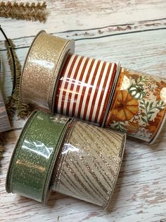 three rolls of washi tape sitting next to each other on top of a wooden table