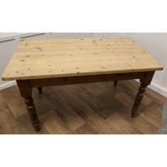 a wooden table sitting on top of a hard wood floor