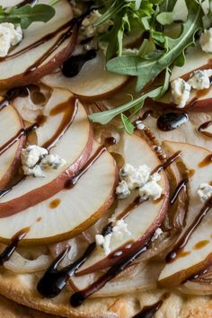 an apple and goat cheese pizza with chocolate sauce drizzled over it's toppings