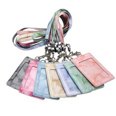 a bunch of different colored tags hanging from a keychain on a white background