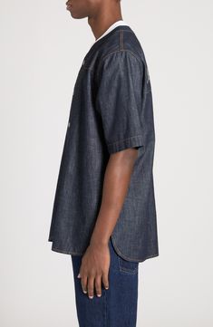 Designed as part of the fashion house's Palermo collection, this softly oversized bowling shirt is cut from indigo-dyed denim and boasts a rope-style back logo. Front snap closure Crewneck Elbow-length sleeves Curved hem 100% cotton Machine wash, line dry Made in Italy Designer Clothing Indigo Short Sleeve Denim Top, Indigo Short Sleeve Cotton Denim Top, Indigo Cotton Denim Top With Short Sleeves, Indigo Relaxed Fit Top With Pockets, Relaxed Fit Indigo Tops With Pockets, Dark Wash Relaxed Fit Denim Top With Short Sleeves, Indigo Denim Short Sleeve Shirt, Indigo Short Sleeve Denim Shirt, Oversized Denim Short Sleeve Tops