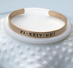 "CURRENT TURNAROUND TIME IS THREE (3) WEEKS ~Personalized Roman Numeral Cuff Bracelet - Special Date Bracelet - Engraved Custom Date Bracelet - Stacking Bracelet - Gift for Her '*.'*.'*.¸What You Will Receive ¸.*''.*''.*'' ❤ One (1) 1/4\" x 6\" brass cuff bracelet with brushed finish ❤ Items will be sent in clear cellophane bags. Boxes/gift packaging can be added at checkout for an additional fee. ❤ '*.'*.'*.¸What I Need To Complete Your Order ¸.*''.*''.*'' (enter the below info in the \"Note\" Gold Stamped Cuff Bracelet For Anniversary, Adjustable Stackable Cuff Bracelet For Anniversary, Customizable Adjustable Vintage Jewelry, Adjustable Customizable Vintage Jewelry, Adjustable Bangle Cuff Bracelet For Anniversary, Vintage Stackable Bangle As Gift, Adjustable Personalized Cuff Jewelry, Date Bracelet, Roman Numerals Dates