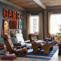 a living room filled with lots of furniture and christmas lights on the wall above it