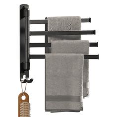 a towel rack with three towels hanging from it's sides and a wooden hanger attached to the wall