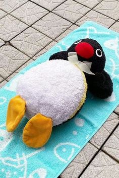 a stuffed animal is laying on a towel