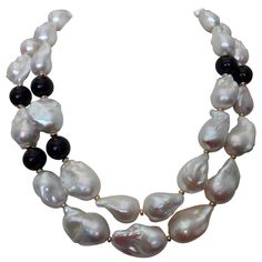 Two strands of enormous baroque Chinese freshwater pearls and black onyx beads comprise this dramatic necklace. The pearls are graduated in size. The largest measures 32mm. Baroque pearls are so casual and easy to dress up or down. The design elements are spaced with gold beads and the necklace is finished with a vermeil hook and eye clasp for ease of wear. Dramatic Necklace, Cocktail Necklace, Abalone Shell Necklace, Tahitian Pearl Necklace, Casual Necklaces, Black Onyx Necklace, Lapis Lazuli Necklace, Double Strand Necklace, Rose Quartz Necklace