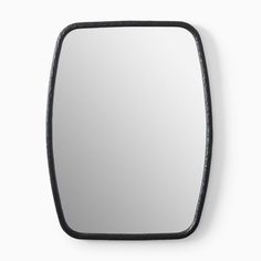 a mirror that is on the wall with a black frame and some white walls behind it