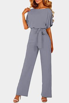 Oh So Glam Belted Wide Leg Jumpsuit is the perfect addition to your wardrobe. This jumpsuit is made from a blend of 95% polyester and 5% spandex, making it comfortable and breathable. The wide leg design gives you a flattering silhouette, while the belted waist adds a touch of sophistication. The jumpsuit features a v-neckline and long sleeves, making it perfect for any occasion. Whether you're headed to the office or out for a night on the town, this jumpsuit will have you looking and fe... Grey Jumpsuit, Long Jumpsuit, Belt Jumpsuit, Jumpsuit Chic, Loose Fitting Tops, Pantalon Large, Pants Design, Wide Pants, Office Fashion