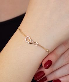 14K Gold Heart and Infinity Symbol Bracelet A symbol of infinite love, this elegant bangle bracelet showcases the symbols of love and eternity entwined with each other. The heart motif perfectly complements the infinity symbol for a truly romantic look. This unique bracelet is perfect for everyday wear as it is made of solid gold and won't tarnish. It is a wonderful gift for a special person. Features: * This bracelet is made of patented 14K solid gold. * It has a 16cm chain and 2cm charm with t Gold Heart Bracelet For Women, Bracelet Ideas Gold Women, Gold Unique Bracelet For Women, Beautiful Bracelet Gold, Women’s Bracelets Gold, Hand Wear Accessories, Fashion And Accessories, Gold Jewelry For Women, A Bracelet Gold