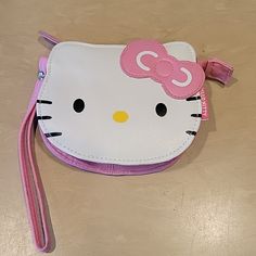 a hello kitty purse with a pink bow on it