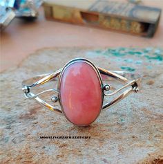 Welcome MoonlightjewelryGift Shop,, Pink Opal Bangle, Boho Bangle, 925 Sterling Silver Bangle, Statement Bangle, Gemstone Bangle, Band Bangle, Wedding Gift, Silver Jewelry, Silver Bangle, Lovely Bangle, Women Bangle, Gift For Women, Handmade Bangle, Promise Bangle, Gift For Her, Benefits of Pink Opal Bangle:- Pink Opal gemstone is believed to hold the most powerful harmonising energy helpful in all heart-related matters: self-acceptance, unconditional love, romantic relationships. Delicate calming vibrations of the gem facilitate emotional healing. This brings the energy of renewal, hope and optimism. Occasion:- Christmas Gift, Birthday Gift, Anniversary Gift, Valentine's Gift, Engagement Gift, Wedding Gift, New Year Gift, Friendship Gift, Girlfriend Gift, Surprise Gift, Office Gift, Emplo Oval Sterling Silver Cuff Bracelet Gift, Pink Round Cuff Bracelet For Gifts, Sterling Silver Bangle Bracelets With Cabochon, Adjustable Oval Sterling Silver Bracelets, Cabochon Bangle Jewelry Gift, Cabochon Bangle As A Gift, Sterling Silver Cabochon Bracelets As Gifts, Opal Bangle, Boho Bangle