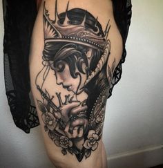 a woman with a crown tattoo on her thigh