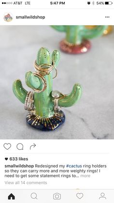 a green cactus figurine sitting on top of a table next to other decorations