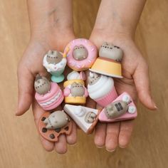 a person's hands holding small toy animals and doughnuts in their palms