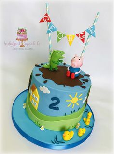 a peppa pig birthday cake on a blue plate