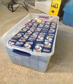 a plastic container filled with lots of beer on top of a carpeted floor in front of a tv