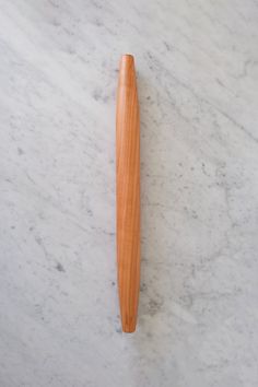 a wooden pen sitting on top of a white marble counter